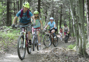 Jeb Wallace-Brodeur / Staff PhotoFormer World Cup downhill bike racer Ali Zimmer of Lincoln, left, leads a womens group ride during National Trails Day festivities at the Blueberry Lake trails in Warren on Sunday. The Mad River Riders mountain bike group received an award from the U.S. Forest Service for their trail building efforts and ground was broken on a new trail being constucted this summer.